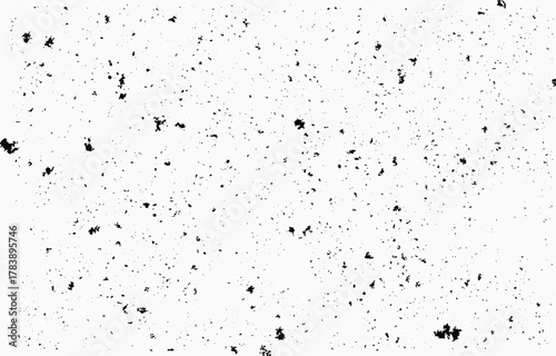 Grunge texture vector with scattered black elements on a white background ideal for design projects, print media, or digital art applications