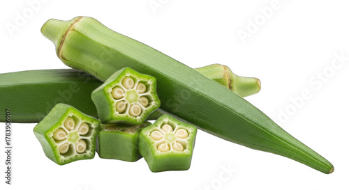 Fresh okra pods and slices on a black background