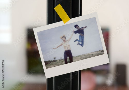 Polaroid on a Glass Panel in a Modern Space