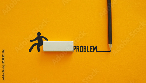 Bild auf Leinwand Solving problems concept - person overcoming the word Problem with pencil and eraser on yellow background