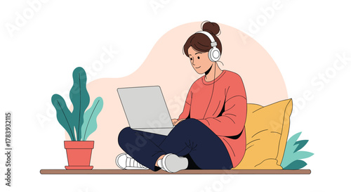 Young woman sitting cross-legged on the floor, comfortably working or studying on her laptop while listening to music with white headphones.