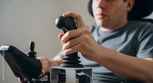 Man using a joystick controller for mobility assistive technology device
