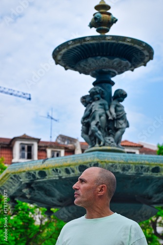 Man in front of a fountain
