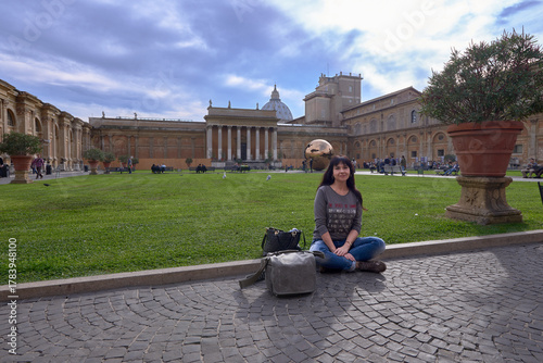 girl sitting on the ground in a garden