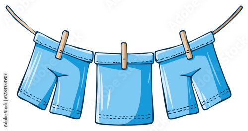 Three blue cartoon shorts drying on a clothesline with wooden clothespins