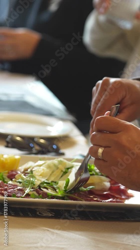 Enjoying a lunch outdoors at an Italian restaurant with traditional dishes on the table