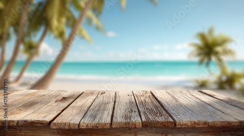 A rustic wooden table sits on the sandy shore. Lush palm trees frame the view of calm turquoise water and a bright sky under gentle sunlight.