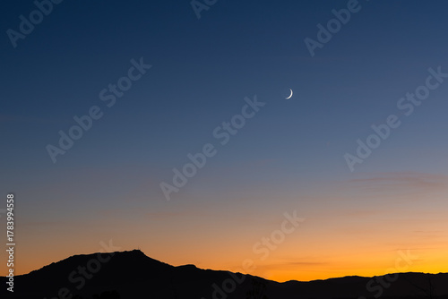 Rhune Mountain in Arcangues by night and crescent moon in the sky. Basque Country.