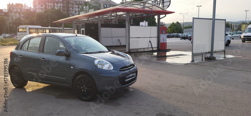 A clean car in front of a car-washing place