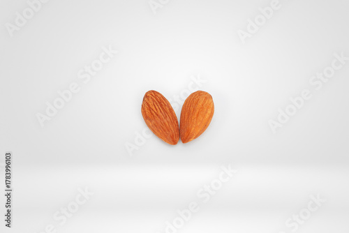 Two Raw Almonds Arranged in a Heart Shape on a Minimalist White Background