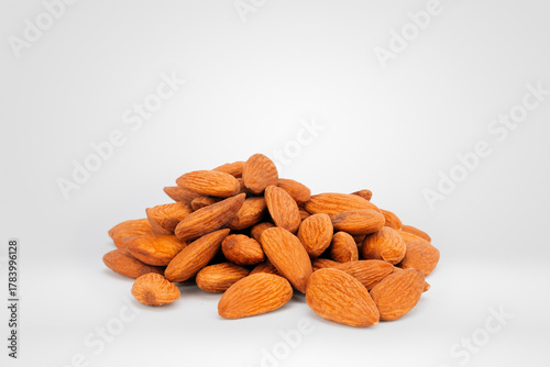 Close-up of a Heap of Raw Almonds on a Plain White Background