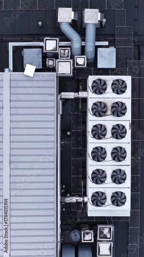 Top-down aerial view of a commercial building rooftop featuring an intricate HVAC, ventilation, and cooling system layout.