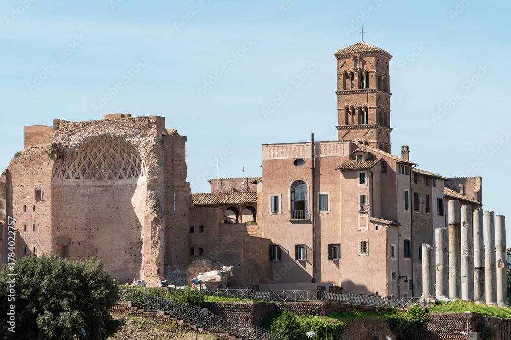 Fototapeta premium Ancient ruins of the Temple of Venus and Roma alongside the Basilica of Santa Francesca Romana, Santa Maria Nova in Rome, Italy