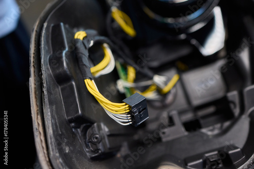Technician analyzing amplifier during workshop inspection, Audio technician conducting diagnostic analysis of car stereo system under laboratory lighting conditions