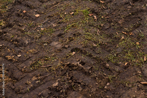 Pattern of tractor tire track imprint in dirt road dried muddy ground, top view