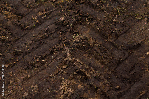 Pattern of tractor tire track imprint in dirt road dried muddy ground, top view