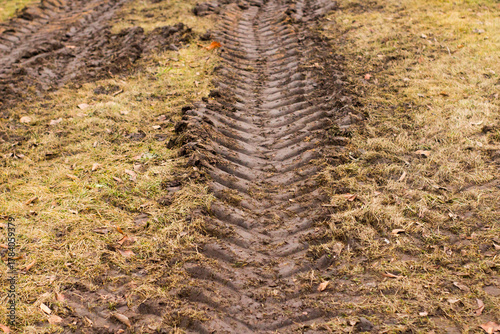 Pattern of tractor tire track imprint in dirt road dried muddy ground, top view