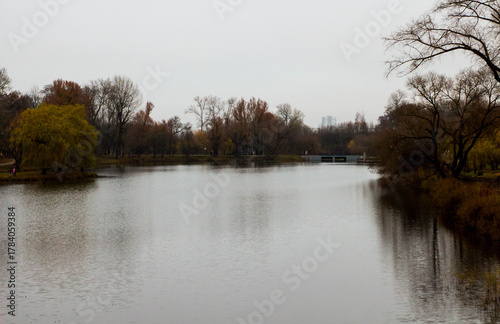A magical autumn landscape of a quiet lake surrounded by forest in sunny weather. Small Polissya, Ukraine, Europe. Fresh and bright colors on the lake. Photo wallpaper. Discovery the beauty of earth.