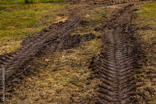 Pattern of tractor tire track imprint in dirt road dried muddy ground, top view
