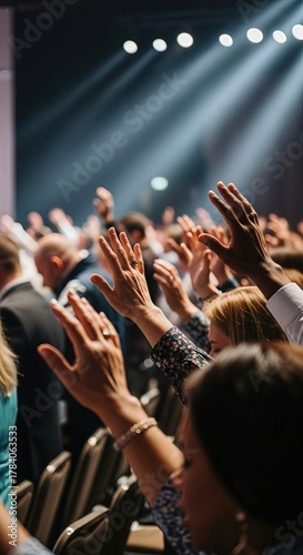 Diverse congregation lifts hands in fervent prayer, showing deep religious faith and spiritual devotion within a sacred church denomination gathering under lights.