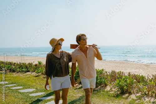 Young caucasian couple enjoying a relaxing beach walk on a sunny day