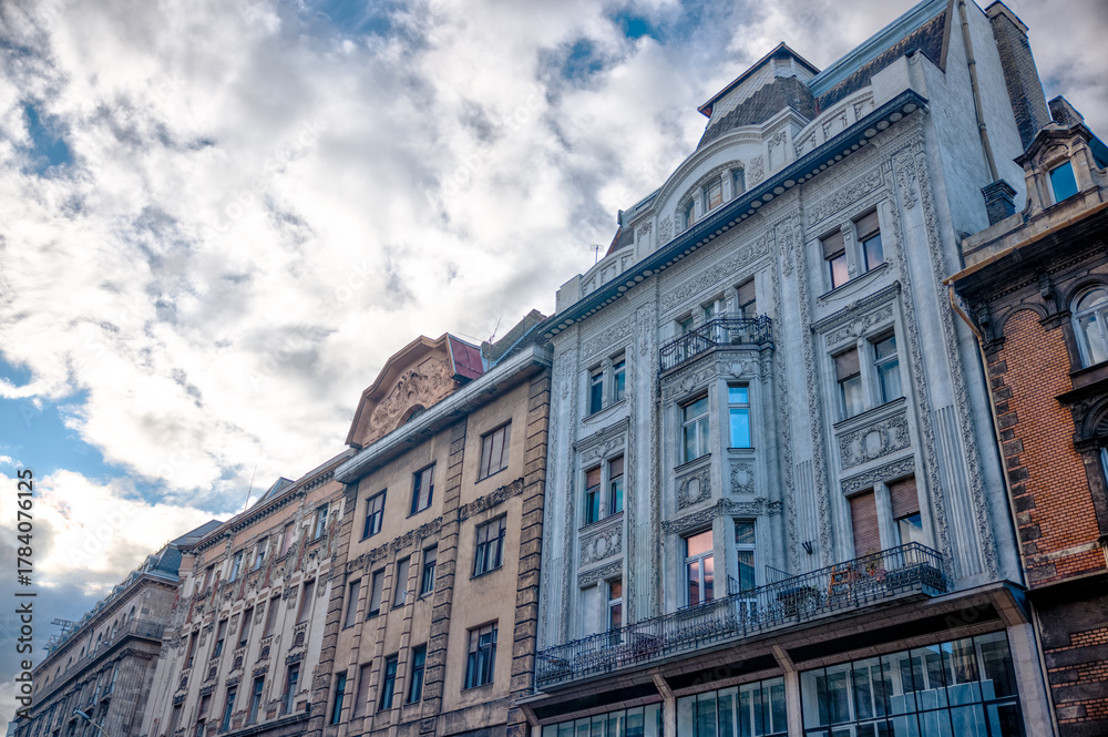Fototapeta premium Budapest, Hungary - July 27, 2025: Traditional residential architecture with colorful facades and ornate details in central Budapest 
