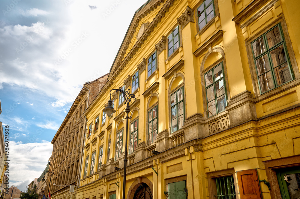 Fototapeta premium Budapest, Hungary - July 27, 2025: Traditional residential architecture with colorful facades and ornate details in central Budapest 
