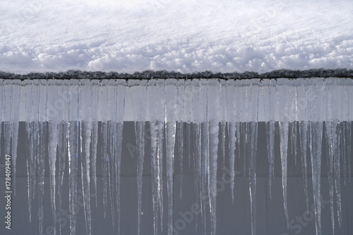 winter house with icicle and snow on the roof
