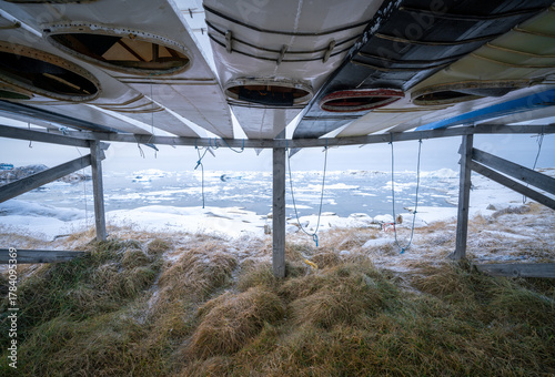 Traditional greenlandic kayaks in the city of Ilulissat, Greenland, on a cold day of late autumn