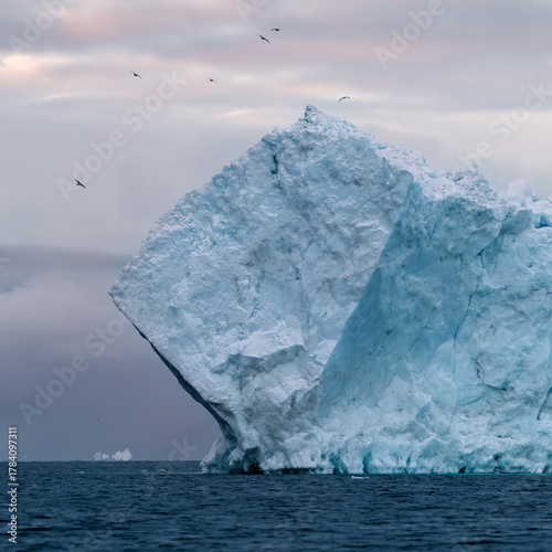 Giant icebergs floating in Ilulisat icefjord, Greenland. Massive icebergs, calved from the Sermeq Kujalleq Glacier, float through the Ilulissat Icefjord in western Greenland