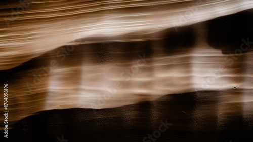 Abstract pattern of light streaks and dark shadows across a textured surface