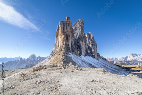 Autumn morning in Tre Cime di Lavaredo National park, Dolomite Alps mountains, Trentino Alto Adige region, Sudtirol, Dolomites, Italy, Europe. Landscape with three peaks of mountain group. Blue sky.