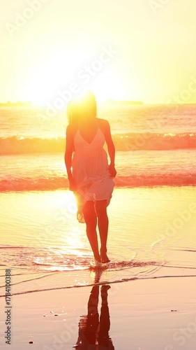 Wallpaper Mural Attractive Asian woman enjoys a walk on the beach at sunset in Southern California. Slow Motion. Vertical Video. Torontodigital.ca