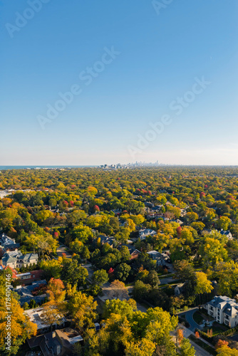 Chicago Northshore suburbs in autumn, colorful trees in residential area by the Lake Michigan, city downtown on the horizon