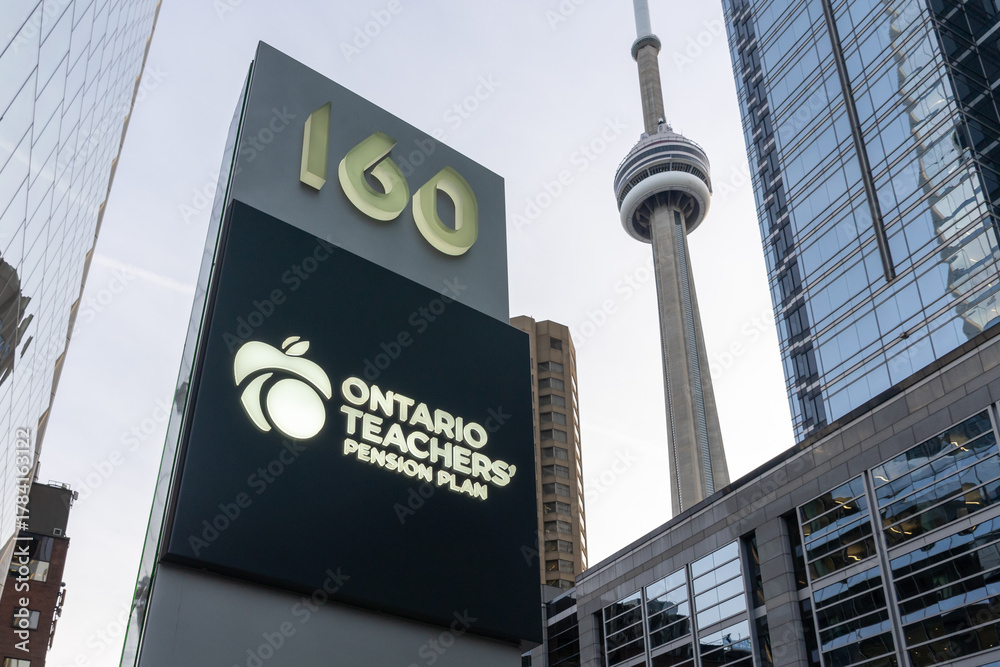 Fototapeta premium Toronto, ON, Canada - November 8, 2025: The sign of Ontario Teachers' Pension Plan (OTPP) with the CN Tower background is seen in Toronto, ON, Canada. OTPP is an independent corporation.