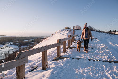 Woman and toddler walking down big steps at Bowmont Park on a clear Wintry day