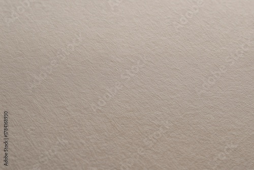 Elegant textured paper background offers a sophisticated, neutral canvas for creative design projects, invitations, and crafting.