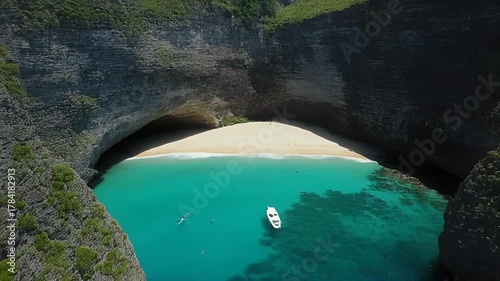 Aerial View Through Limestone Archway Revealing Tropical Beach Turquoise Water and Boat