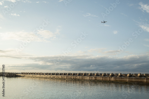 a air plane crossing in evening blue sky on the ocean in jeju island