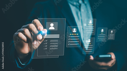 Businessman using digital interface to evaluate employee profiles and performance rating system. Concept of HR technology, recruitment, data analysis, and human resources management.
