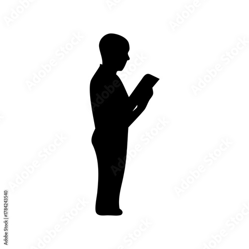 Silhouette of a person engrossed in reading a book or magazine