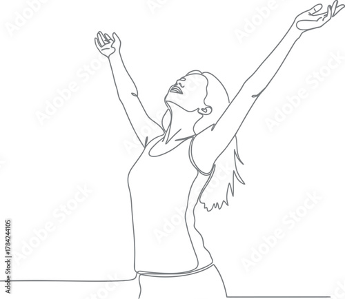 Joyful woman with arms raised in celebration and freedom