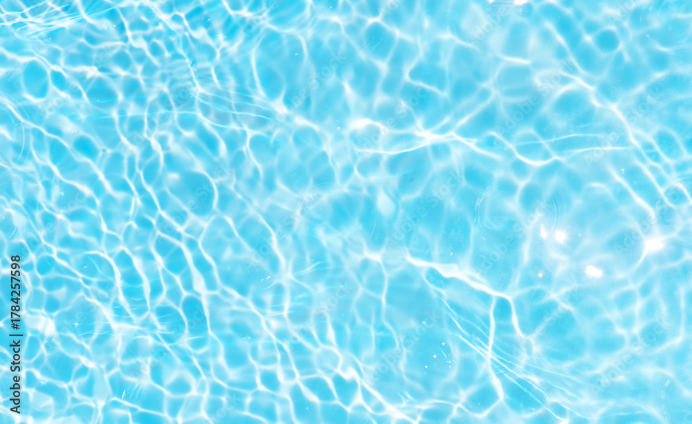 Obraz premium Blue water with ripples on the surface. Defocus blurred transparent blue colored clear calm water surface texture with splashes and bubbles. Water waves with shining pattern texture background.