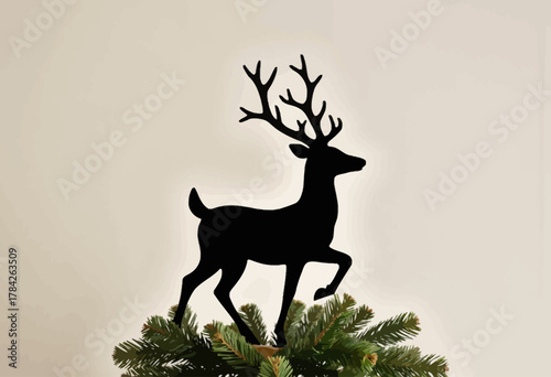 Silhouette of a Decorative Reindeer with Antlers atop a Spruce Branch Creating a Festive and Elegant Holiday Atmosphere