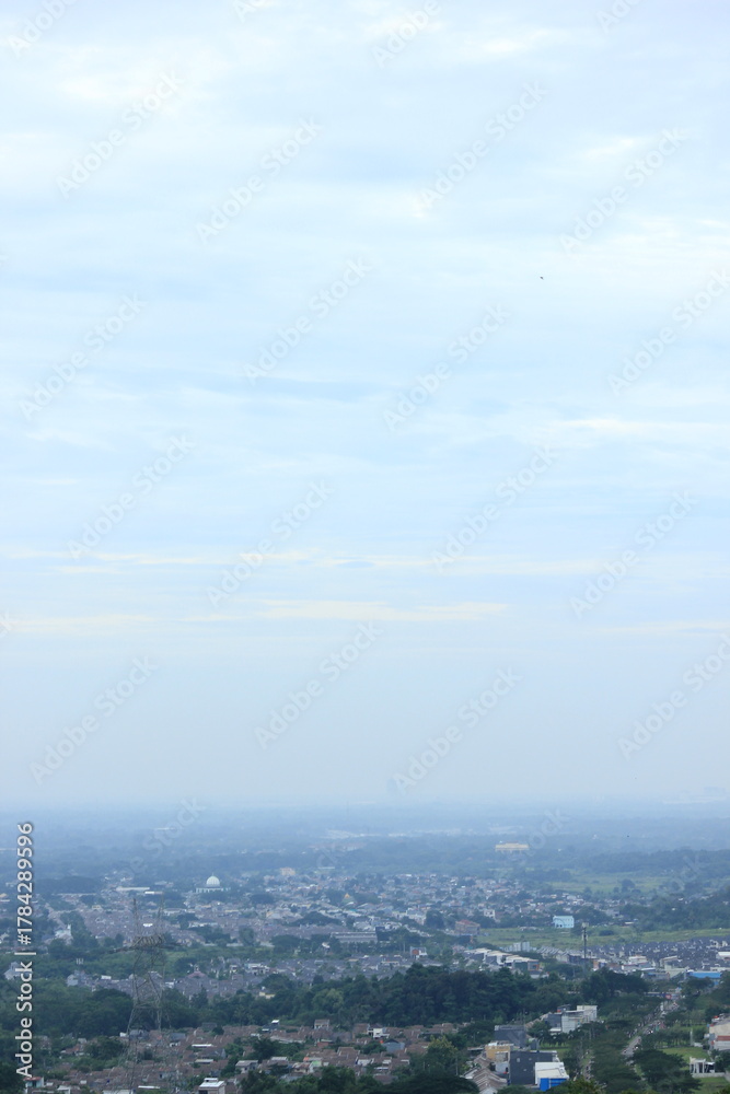 Fototapeta premium Panoramic City View with Lush Green Hills