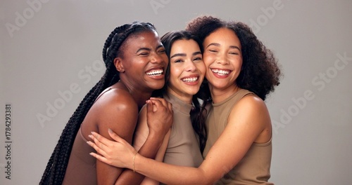 Fotografía Happy women, portrait and hug with diversity, beauty or hair for fashion on a studio background