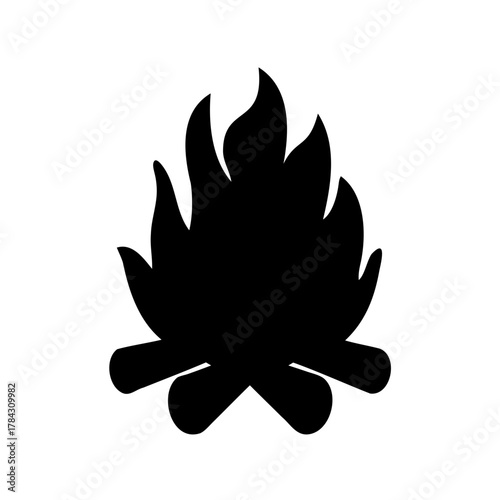 Silhouette of a blazing campfire with flickering flames and burning logs