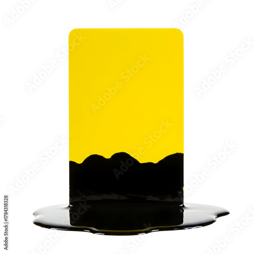 Yellow rectangular object partially submerged in black liquid.
