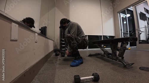 Man Performing Goblet Squats with Dumbbell

