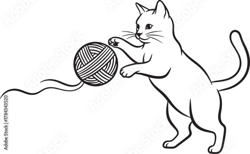 Playful cat unraveling a ball of yarn